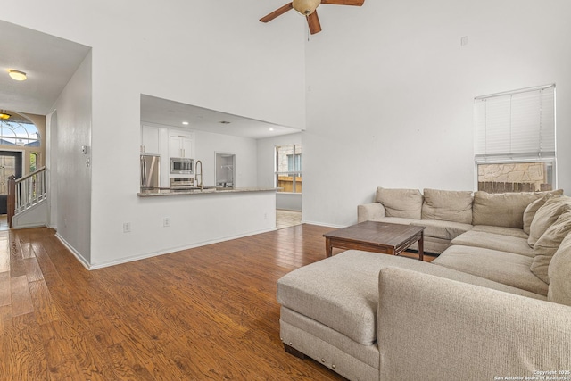 6218 Ozona Ml, San Antonio, TX 78253 - living area featuring baseboards, wood finished floors, a high ceiling, ceiling fan, and stairs