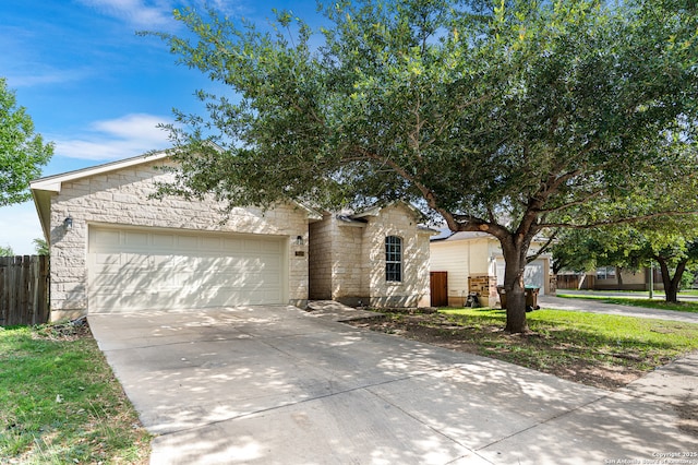 7619 Bit Cir, Elmendorf, TX 78112 - view of front of home with driveway, stone siding, and a garage
