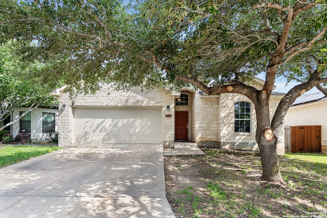 7619 Bit Cir, Elmendorf, TX 78112 - view of front of property with a garage, stone siding, and driveway