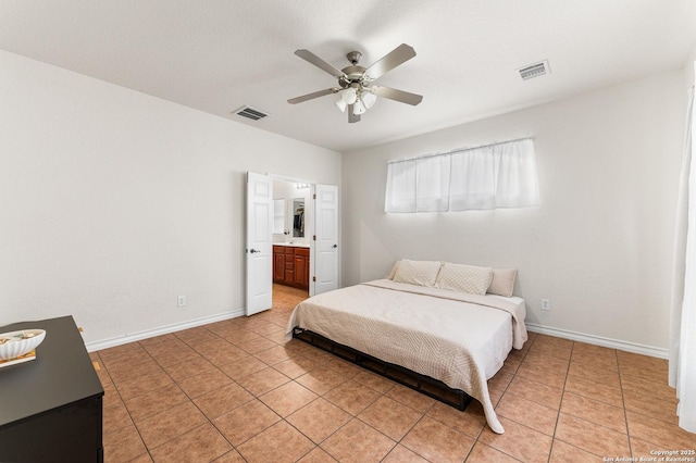 7619 Bit Cir, Elmendorf, TX 78112 - bedroom with light tile patterned floors, baseboards, ceiling fan, and ensuite bath