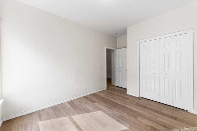 7619 Bit Cir, Elmendorf, TX 78112 - unfurnished bedroom featuring light wood finished floors, a closet, and baseboards