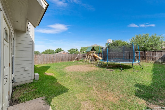 7619 Bit Cir, Elmendorf, TX 78112 - view of yard with a trampoline and a playground