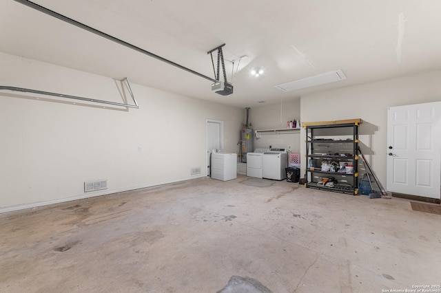 7619 Bit Cir, Elmendorf, TX 78112 - garage featuring washing machine and clothes dryer, a garage door opener, and water heater