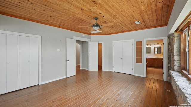 1001 Naked Indian, New Braunfels, TX 78132 - unfurnished bedroom featuring wood ceiling, light wood finished floors, ensuite bathroom, crown molding, and baseboards