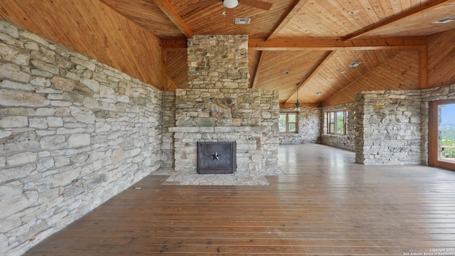 1001 Naked Indian, New Braunfels, TX 78132 - unfurnished living room with wooden ceiling with exposed beams, hardwood / wood-style flooring, high vaulted ceiling, a stone fireplace, and ceiling fan