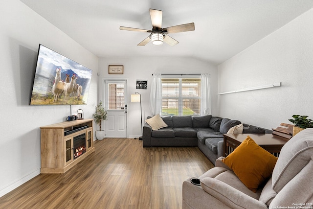 6417 Hoffman Pln, San Antonio, TX 78252 - living room featuring wood finished floors, a ceiling fan, lofted ceiling, baseboards, and a glass covered fireplace