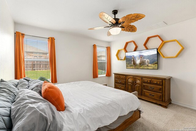 6417 Hoffman Pln, San Antonio, TX 78252 - bedroom featuring multiple windows, light carpet, baseboards, and a ceiling fan
