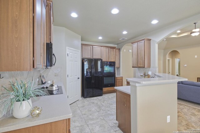 8022 Grissom Crst, San Antonio, TX 78251 - kitchen with black appliances, arched walkways, a peninsula, tasteful backsplash, and recessed lighting