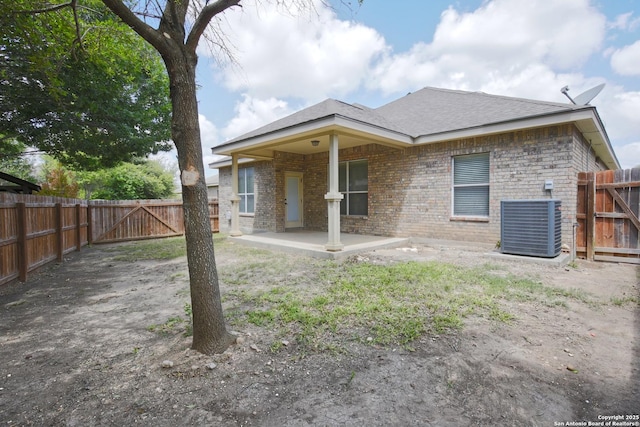 8022 Grissom Crst, San Antonio, TX 78251 - rear view of property with central AC unit, a patio area, a fenced backyard, and brick siding