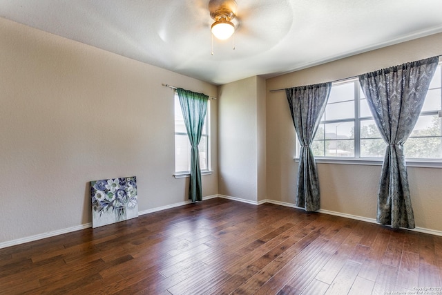 8227 Maloy Mnr, San Antonio, TX 78250 - spare room featuring healthy amount of natural light, a ceiling fan, wood finished floors, and baseboards