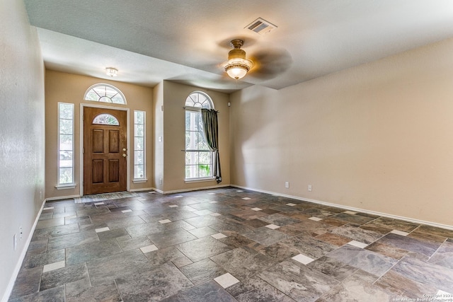 8227 Maloy Mnr, San Antonio, TX 78250 - foyer entrance with baseboards, healthy amount of natural light, and stone tile flooring