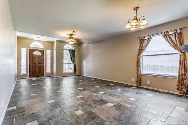 8227 Maloy Mnr, San Antonio, TX 78250 - entrance foyer with baseboards, stone tile floors, and a chandelier