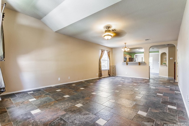 8227 Maloy Mnr, San Antonio, TX 78250 - empty room with stone tile flooring, arched walkways, a chandelier, and baseboards