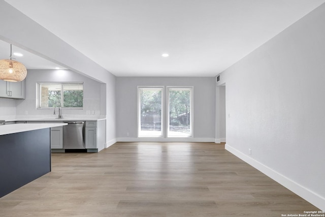 5411 Lancashire, San Antonio, TX 78230 - kitchen featuring stainless steel dishwasher, light countertops, a sink, healthy amount of natural light, and recessed lighting