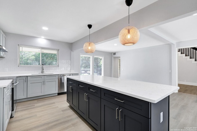 5411 Lancashire, San Antonio, TX 78230 - kitchen with stainless steel dishwasher, tasteful backsplash, a sink, range with electric stovetop, and light wood-style floors