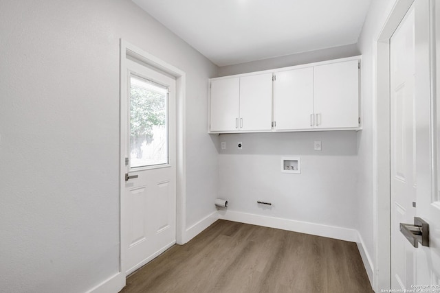 5411 Lancashire, San Antonio, TX 78230 - washroom with electric dryer hookup, cabinet space, washer hookup, baseboards, and wood finished floors