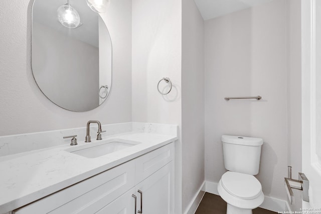 5411 Lancashire, San Antonio, TX 78230 - half bathroom featuring vanity, toilet, and baseboards