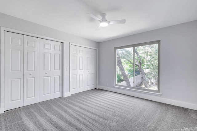 5411 Lancashire, San Antonio, TX 78230 - unfurnished bedroom featuring two closets, carpet, baseboards, and ceiling fan