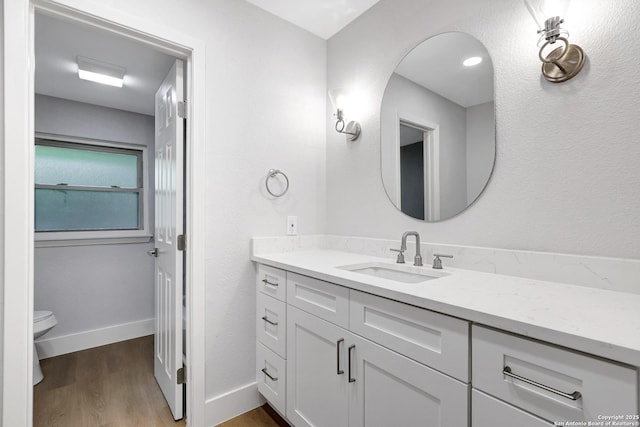5411 Lancashire, San Antonio, TX 78230 - bathroom with vanity, toilet, wood finished floors, and baseboards