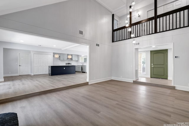 5411 Lancashire, San Antonio, TX 78230 - unfurnished living room featuring high vaulted ceiling, light wood-style floors, and baseboards