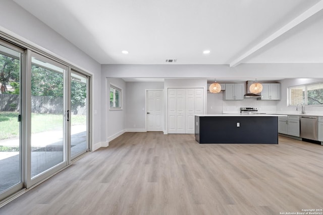 5411 Lancashire, San Antonio, TX 78230 - kitchen featuring stainless steel appliances, wall chimney exhaust hood, gray cabinets, light countertops, and a kitchen island