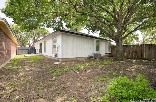 11375 Olney Spgs, San Antonio, TX 78245 - back of house featuring a fenced backyard and central AC unit