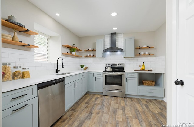 11375 Olney Spgs, San Antonio, TX 78245 - kitchen featuring open shelves, wall chimney range hood, stainless steel appliances, a sink, and recessed lighting