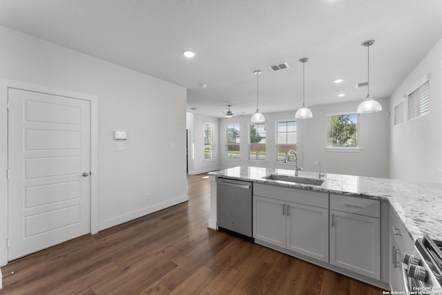 9607 Stillwater Pass, San Antonio, TX 78254 - kitchen featuring appliances with stainless steel finishes, a sink, dark wood-style floors, light stone countertops, and recessed lighting