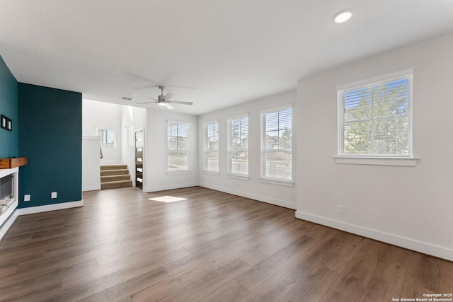 9607 Stillwater Pass, San Antonio, TX 78254 - unfurnished living room with baseboards, stairs, a ceiling fan, and wood finished floors