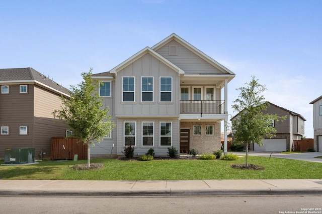 9607 Stillwater Pass, San Antonio, TX 78254 - view of front of house featuring board and batten siding, a balcony, a garage, and a front lawn
