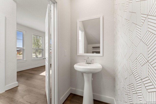 9607 Stillwater Pass, San Antonio, TX 78254 - bathroom featuring wood finished floors, baseboards, and a sink