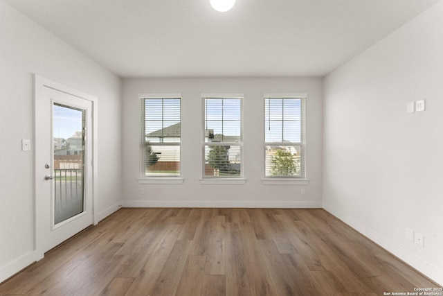 9607 Stillwater Pass, San Antonio, TX 78254 - unfurnished room featuring light wood-style flooring, plenty of natural light, and baseboards