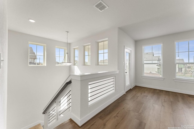 9607 Stillwater Pass, San Antonio, TX 78254 - corridor with healthy amount of natural light, baseboards, wood finished floors, and recessed lighting