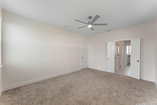9607 Stillwater Pass, San Antonio, TX 78254 - unfurnished bedroom with light carpet, baseboards, a ceiling fan, and ensuite bathroom