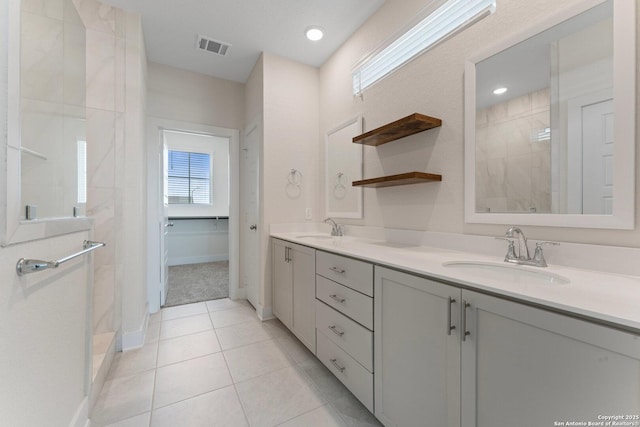 9607 Stillwater Pass, San Antonio, TX 78254 - full bathroom with double vanity, tiled shower, tile patterned floors, and baseboards