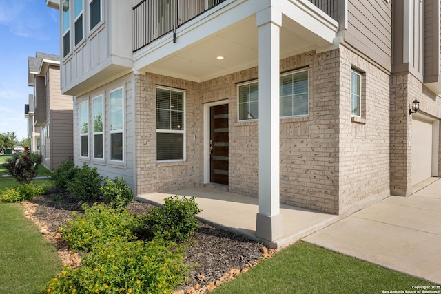9607 Stillwater Pass, San Antonio, TX 78254 - property entrance with concrete driveway, a balcony, brick siding, and a garage