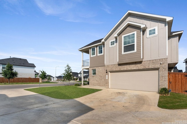 9607 Stillwater Pass, San Antonio, TX 78254 - view of front of home featuring an attached garage, driveway, board and batten siding, and brick siding