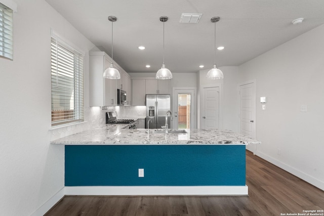 9607 Stillwater Pass, San Antonio, TX 78254 - kitchen with appliances with stainless steel finishes, a sink, a peninsula, recessed lighting, and dark wood finished floors
