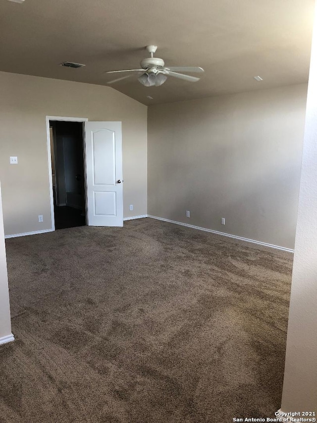 5514 Justin, San Antonio, TX 78240 - spare room featuring ceiling fan, dark carpet, vaulted ceiling, and baseboards