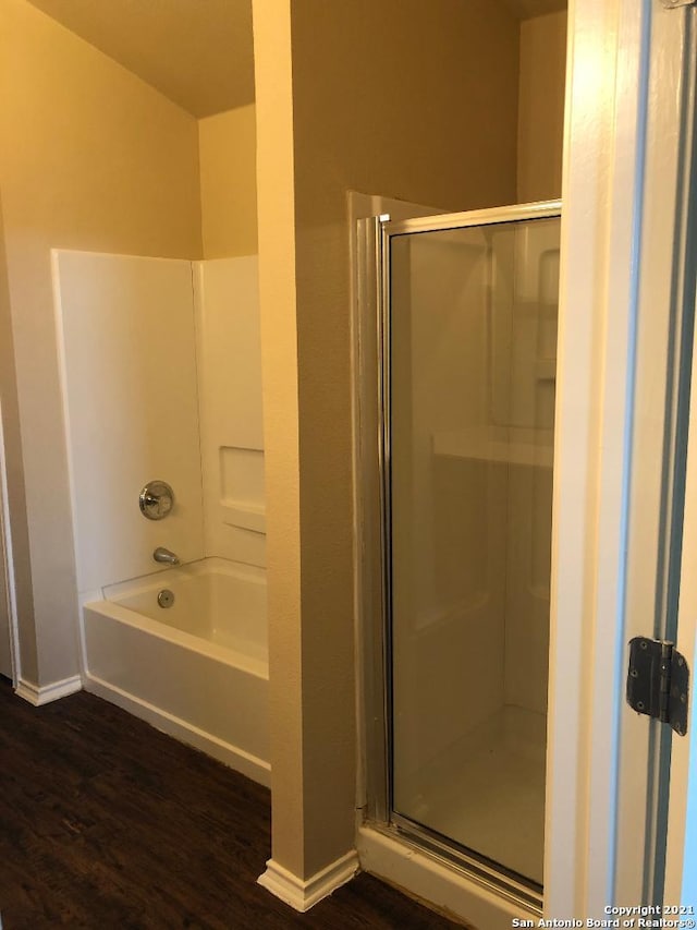 5514 Justin, San Antonio, TX 78240 - full bathroom featuring wood finished floors, baseboards, a shower stall, and a garden tub