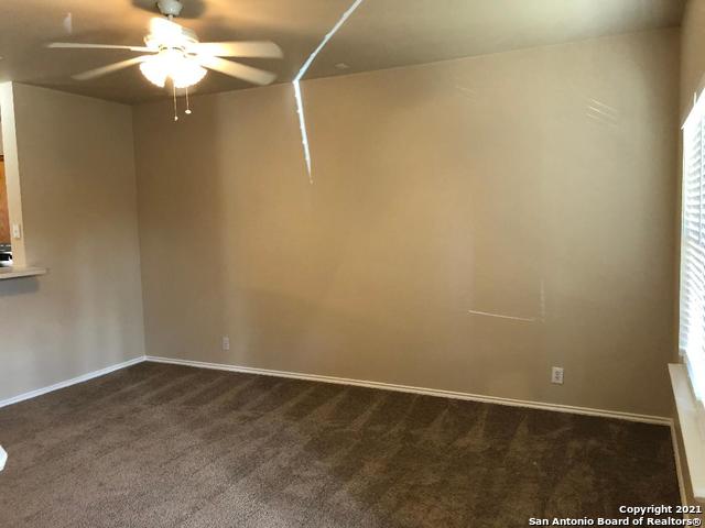 5514 Justin, San Antonio, TX 78240 - unfurnished room featuring a ceiling fan, dark carpet, and baseboards