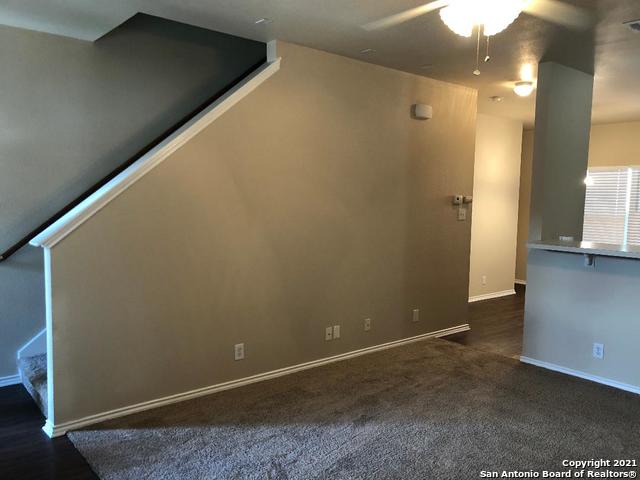 5514 Justin, San Antonio, TX 78240 - spare room featuring a ceiling fan, stairway, and baseboards