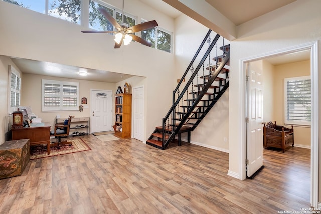 246 Felisa St, San Antonio, TX 78210 - entrance foyer with wood finished floors, stairs, ceiling fan, plenty of natural light, and a high ceiling