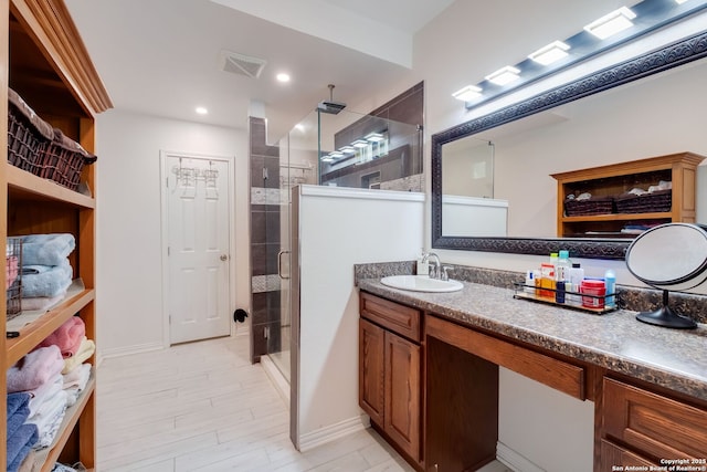 246 Felisa St, San Antonio, TX 78210 - full bathroom with a shower stall, vanity, baseboards, wood finished floors, and recessed lighting