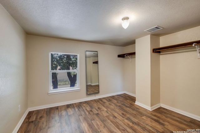 246 Felisa St, San Antonio, TX 78210 - unfurnished bedroom featuring wood finished floors, a textured ceiling, and baseboards