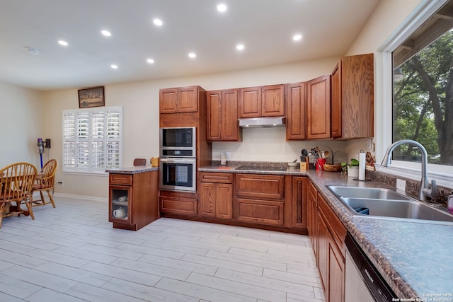 246 Felisa St, San Antonio, TX 78210 - kitchen with black appliances, a sink, brown cabinets, under cabinet range hood, and recessed lighting