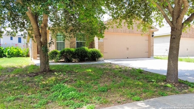 11439 Luckey Ledge, San Antonio, TX 78252 - obstructed view of property featuring concrete driveway, an attached garage, and brick siding