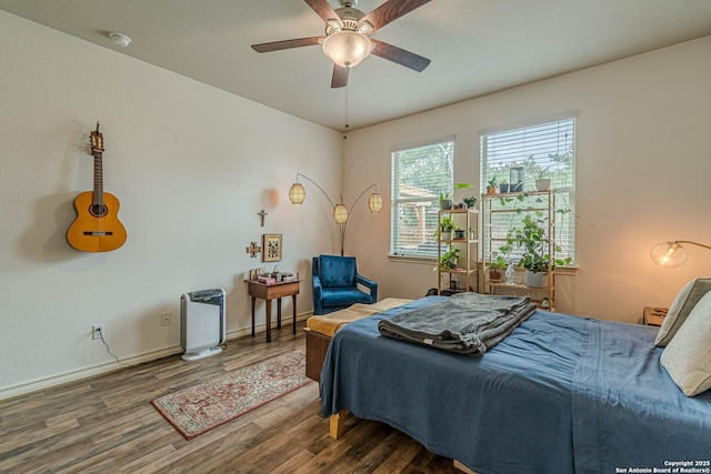 124 Mary Max Cir, San Marcos, TX 78666 - bedroom with wood finished floors, baseboards, heating unit, and a ceiling fan