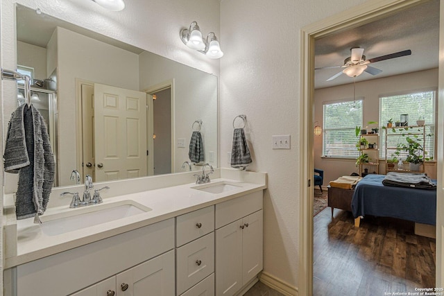 124 Mary Max Cir, San Marcos, TX 78666 - full bathroom with double vanity, a ceiling fan, baseboards, wood finished floors, and ensuite bathroom