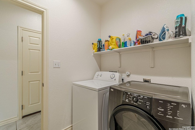124 Mary Max Cir, San Marcos, TX 78666 - laundry room with washer and dryer, light tile patterned flooring, and baseboards